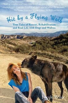 Book cover of Hit by a Flying Wolf: True Tales of Rescue, Rehabilitation and Real Life with Dogs and Wolves